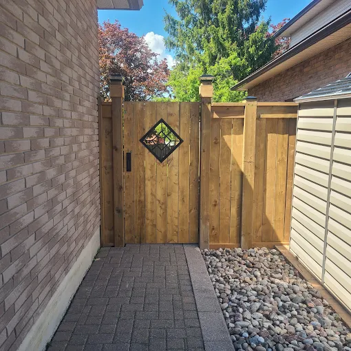 Custom cedar privacy gate with stained glass inlay and matching fence